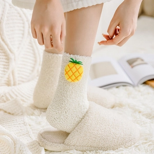 Detail of soft coral fleece winter socks with 3D pineapple charm and plush slippers