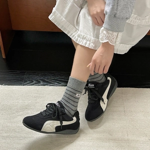 Retro striped mid-tube socks paired with black suede sneakers and a white lace skirt
