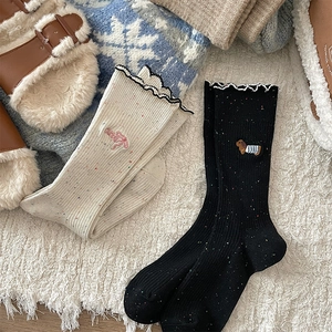 Detail of wool blend socks with lettuce edge cuffs and cute cartoon puppy embroidery