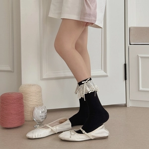 Ballet style black knee high socks with white lace trim and ribbon bow accents