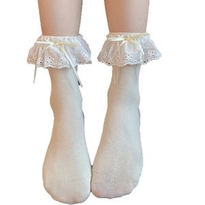 Lolita style cream white mid-calf socks with delicate lace trim and yellow ribbon bow
