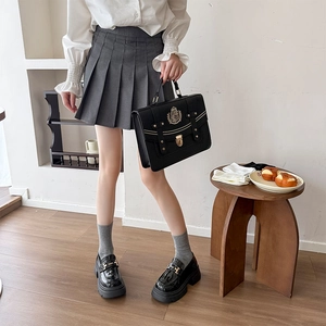 Preppy style outfit with pleated skirt, leather loafers and vintage satchel bag detail