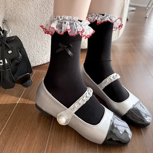 Floral lace socks with black satin bow paired with silver pearl Mary Jane shoes