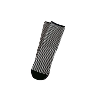 Classic black and white striped cotton crew socks for women in a minimalist flat lay