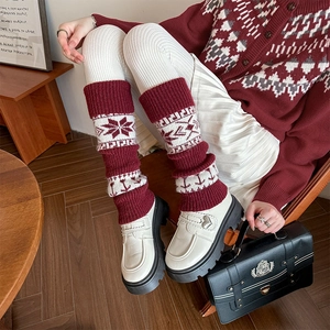Vintage red and white knitted leg warmers with snowflake patterns and ribbed cuffs