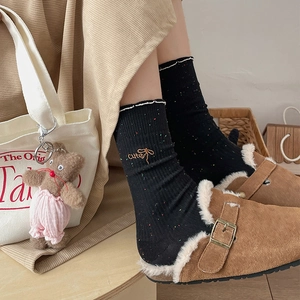Japanese style black knit mid-calf socks with colorful speckles and embroidery