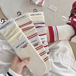 Close-up of vintage preppy striped socks with heart texture and brand packaging