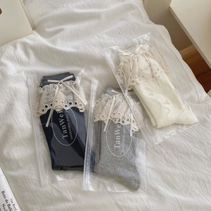 Detail of ballet style bow socks with lace trim in black, grey and beige colors