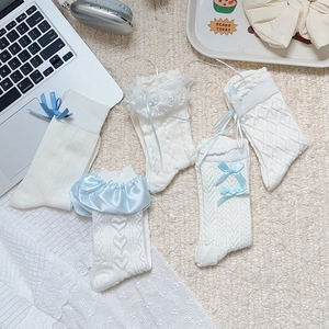 Detailed view of white Lolita socks featuring blue ribbon bows and delicate lace trims