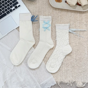 White Lolita lace trim knee high socks with light blue bows and varied knit patterns