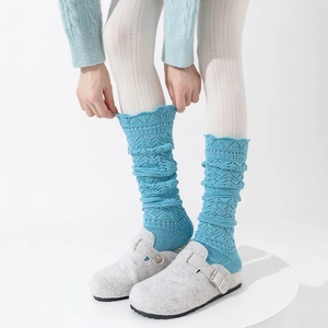 Detailed knit pattern on lake blue slouch socks with hollow lace and scalloped edges