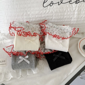 Detail view of cotton socks with floral lace trim and delicate bows in various colors
