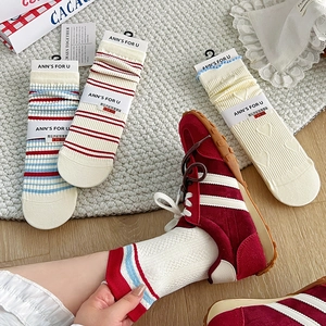 Detail of red and blue striped cotton socks with sweet heart lace and elastic cuffs