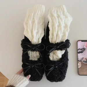 Detail of cable knit leg warmers with fuzzy faux fur Mary Jane shoes and bow accents