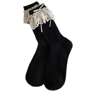 Ballet style black mid-calf socks with cream lace trim and bowknot detail on white background