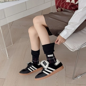 British style plaid socks with vintage tag worn with classic retro sneakers