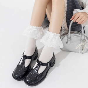 Close-up of Mary Jane shoes with hollow lace socks and bow detailing in Lolita style