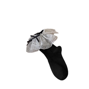 Lolita style black ankle socks featuring white lace trim and sweet bow details