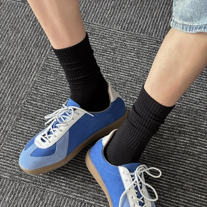 Detailed top view of blue suede German Army Trainers with vintage gum rubber soles
