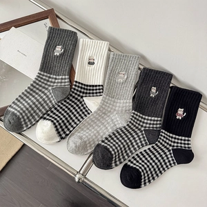 Detail of 5-pack crew socks with cat embroidery and classic checkered knit patterns