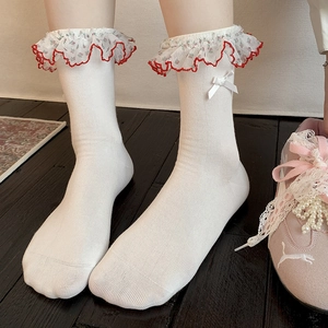 Detail of white crew socks with red floral lace trim and delicate satin bow accents