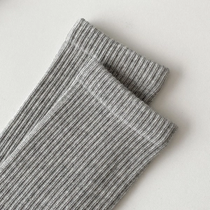 Detail of light grey crew sock featuring premium vertical ribbed knit texture and soft fabric