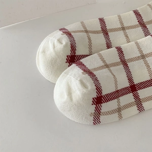 Close-up of the smooth toe seam and red plaid pattern on Japanese style cotton crew socks