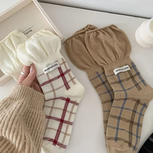 Detail of plaid crew socks with ruffled cuffs and vintage Japanese style patterns