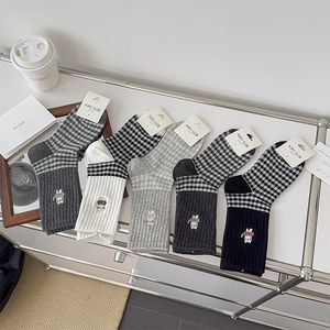 Detail of 5-pack crew socks featuring black and white plaid with cute rabbit embroidery