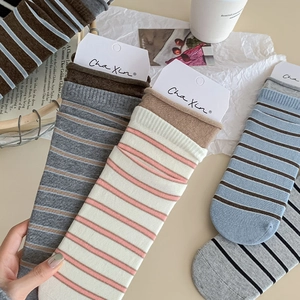 Detail shot of vintage blue and grey striped knit socks with brand tag and cozy styling
