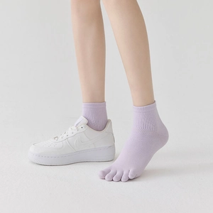 Close-up of light purple five-finger socks with ribbed cuffs and breathable knit texture