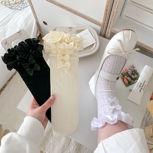 Close-up of Lolita lace socks featuring intricate hollow mesh and delicate ribbon bows