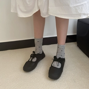 Classic black Mary Jane flat shoes with bow details and matching grey ribbon socks