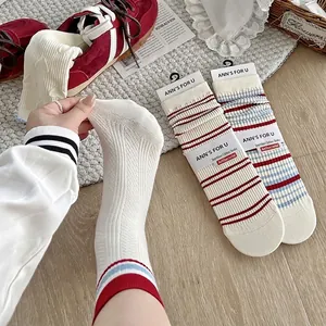 Retro collegiate style white slouch socks with red and blue stripes and heart lace trim