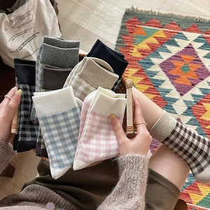 Detailed view of colorful plaid pattern crew socks with soft ribbed knit texture