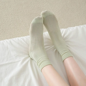 Light green breathable mid-calf socks for women in soft cream color and minimalist style