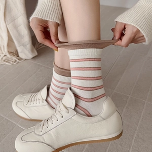 Detail of blue and brown striped socks with elastic ribbed cuffs and retro style