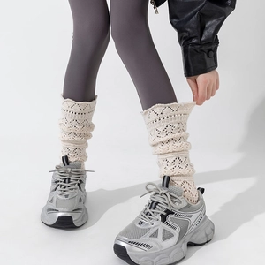 Detail of cream white knit calf socks featuring vintage diamond hollow mesh pattern