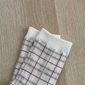Detailed macro view of classic brown checkered knit pattern and ribbed cuff on cotton socks