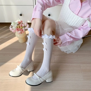 Detailed view of white Lolita lace socks with ribbon bows and Mary Jane shoes