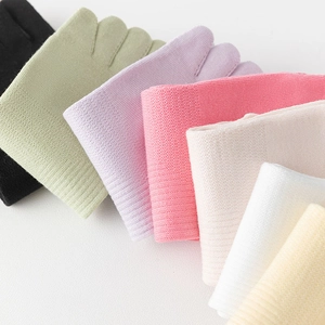 Close-up of pastel cotton knit five-finger socks showing vertical ribbed texture and elastic