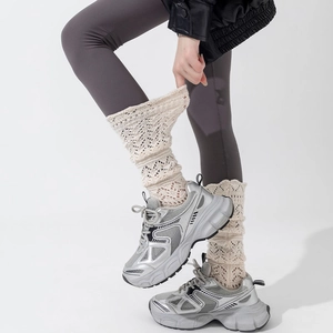 Silver platform sneakers paired with cream crochet knit leg warmers in a stylish look