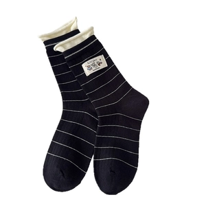 Classic black and white striped cotton crew socks with rolled cuffs and brand patch