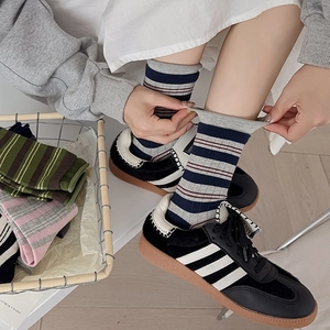 Close-up showing the elastic cuff and striped pattern of these cotton crew socks