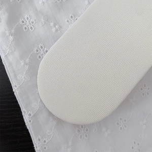 Macro detail of breathable white mesh fabric on feminine ruffled crew socks with a soft texture