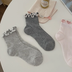 Detail of ruffled cuffs and ribbed texture on pastel cotton blend crew socks