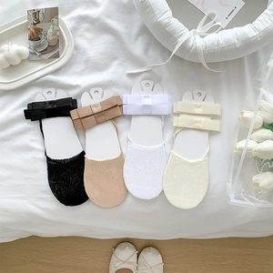 Macro view of four-color ballet style invisible low cut socks with delicate bow details