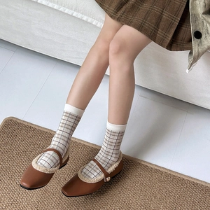 British style brown plaid socks paired with matte leather Mary Jane shoes and fuzzy lining