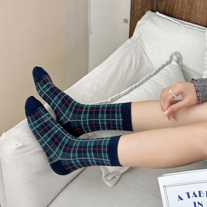 Detail of British style green plaid socks with cotton texture and retro knit pattern