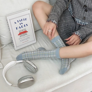 British style light blue plaid mid-calf socks with rib cuffs shown in a lifestyle setting
